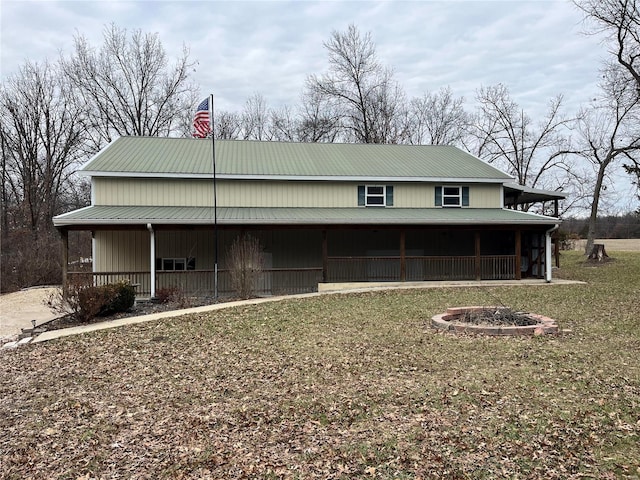 view of property exterior with a fire pit and a lawn