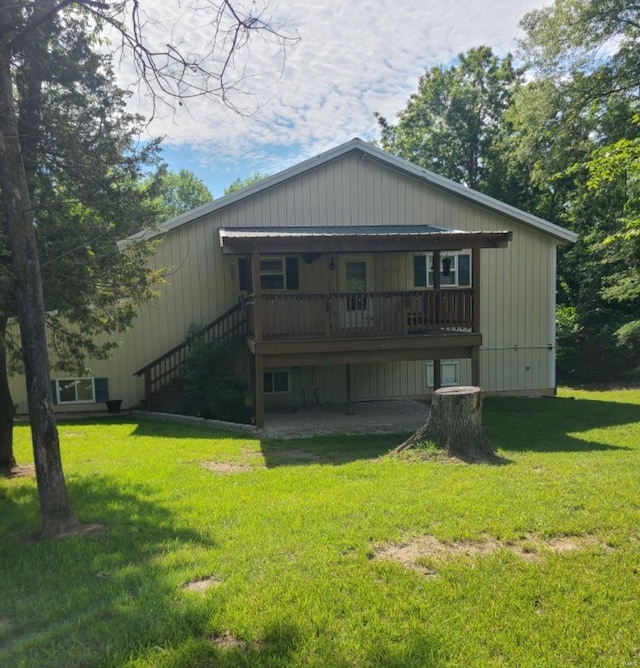 rear view of property with a yard