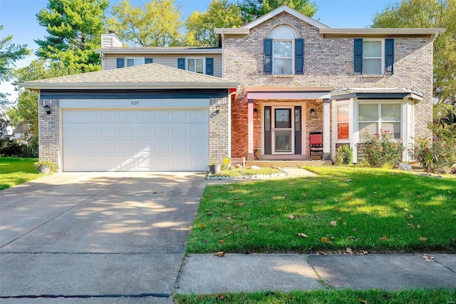 view of front of house with a garage and a front lawn