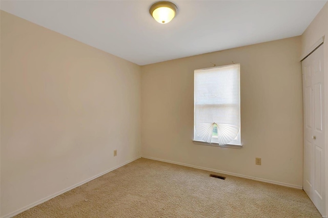 empty room featuring light colored carpet