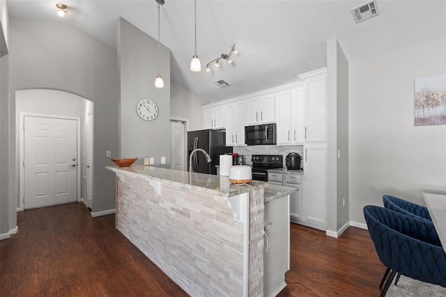 kitchen with white cabinetry, light stone counters, decorative light fixtures, an island with sink, and black appliances