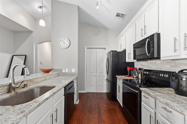 kitchen featuring white cabinets, light stone countertops, sink, and black appliances