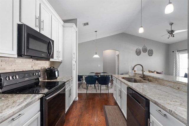 kitchen featuring sink, decorative light fixtures, black appliances, light stone countertops, and white cabinets