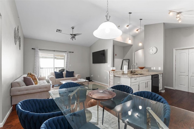 dining room featuring vaulted ceiling, sink, dark wood-type flooring, and ceiling fan