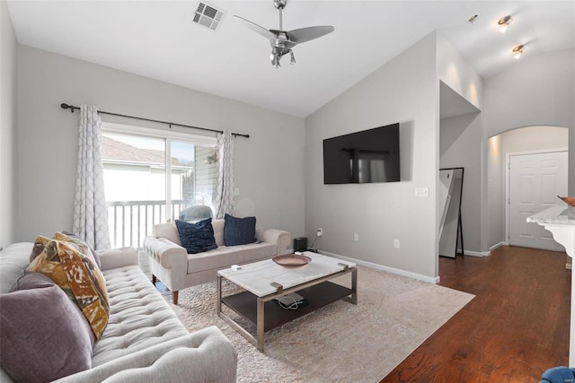 living room featuring vaulted ceiling, dark hardwood / wood-style floors, and ceiling fan