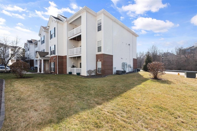 view of property exterior featuring central air condition unit and a lawn