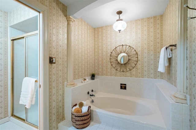 full bathroom with wallpapered walls, a garden tub, a stall shower, and ornate columns