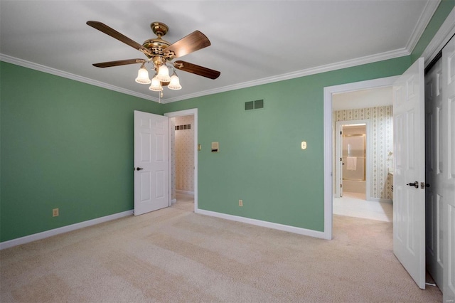 unfurnished bedroom featuring crown molding, carpet flooring, and visible vents