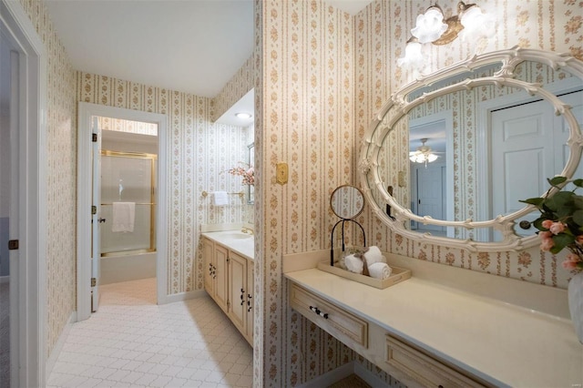 bathroom featuring wallpapered walls and vanity