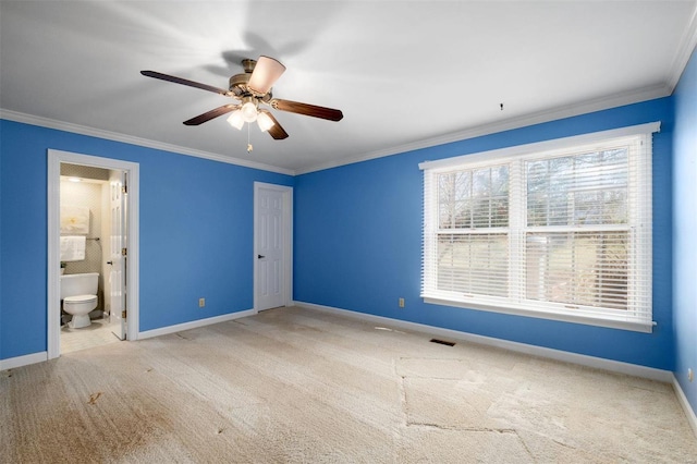 unfurnished bedroom featuring carpet floors, ensuite bath, baseboards, and ornamental molding