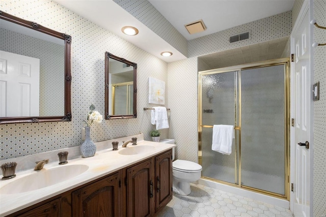 full bathroom with a sink, visible vents, a stall shower, and wallpapered walls