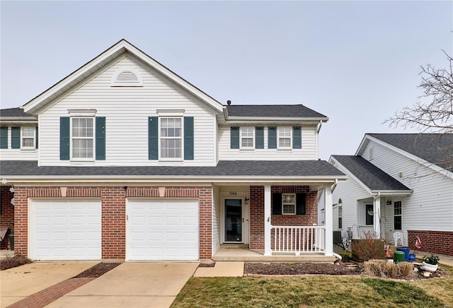 view of front of house with a garage, a front yard, and covered porch