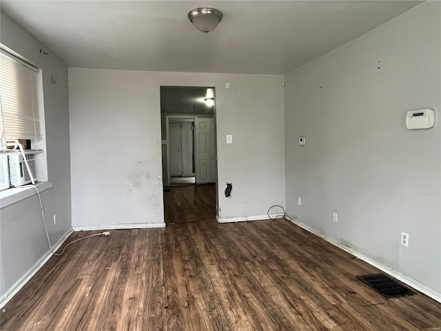 empty room featuring dark wood-type flooring