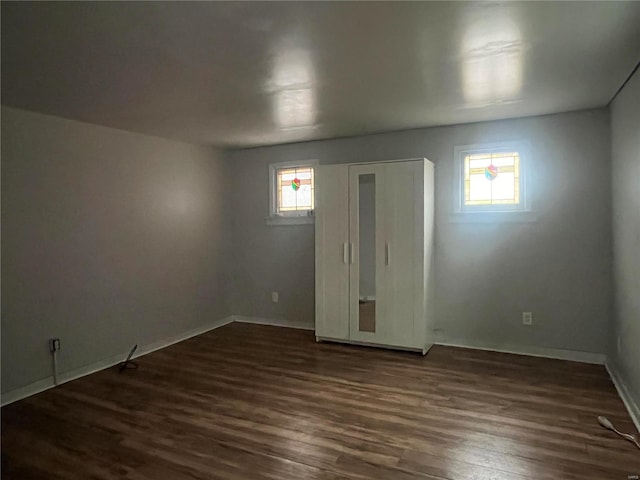 empty room with dark wood-type flooring