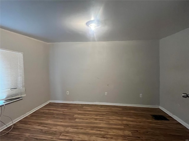 spare room featuring dark hardwood / wood-style floors