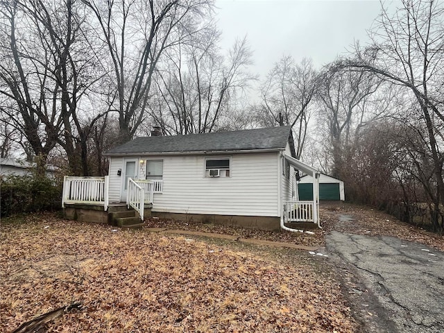 view of front of house with a garage and an outdoor structure