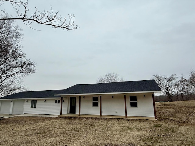 ranch-style home with a garage and a front lawn