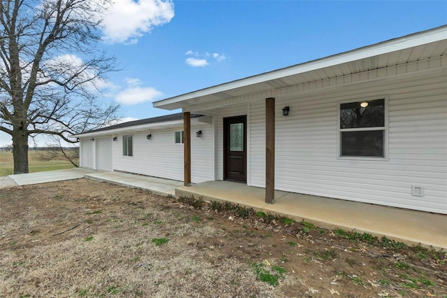 exterior space featuring covered porch and concrete driveway