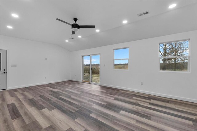 unfurnished room featuring lofted ceiling, baseboards, visible vents, and recessed lighting