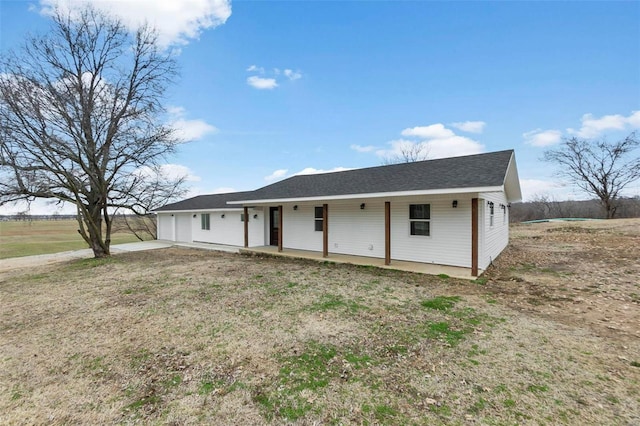 ranch-style home featuring roof with shingles