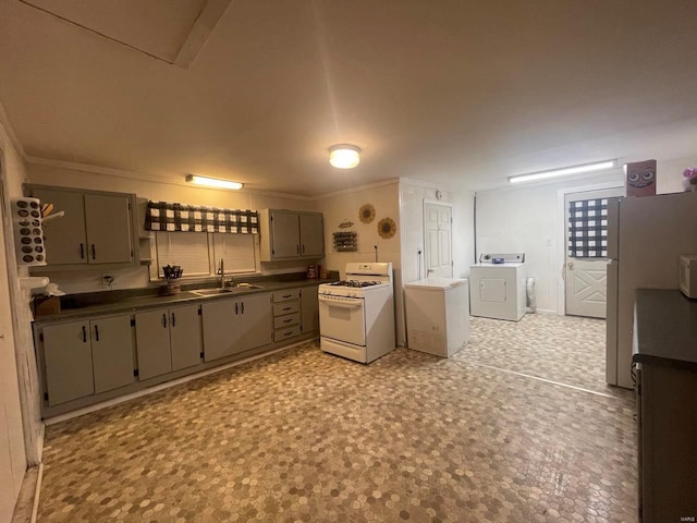 kitchen with gray cabinets, washer / clothes dryer, sink, ornamental molding, and white appliances