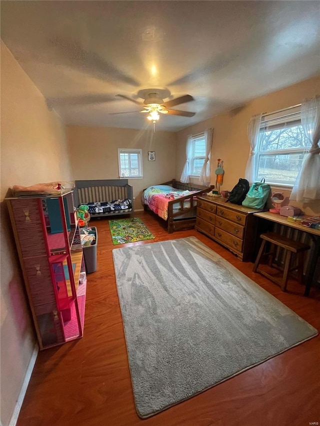 bedroom with wood-type flooring and ceiling fan