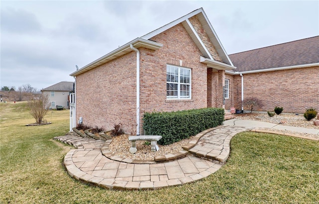 view of side of home with a lawn