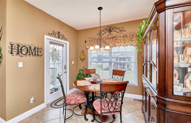 dining space featuring an inviting chandelier and light tile patterned floors