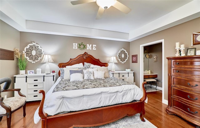 bedroom with light hardwood / wood-style floors, ceiling fan, and ensuite bathroom