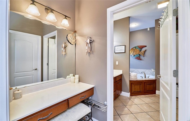 bathroom featuring vanity, a tub to relax in, and tile patterned floors