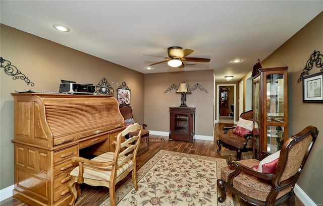 living area featuring ceiling fan and hardwood / wood-style floors