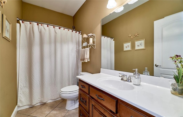 bathroom featuring tile patterned flooring, vanity, and toilet