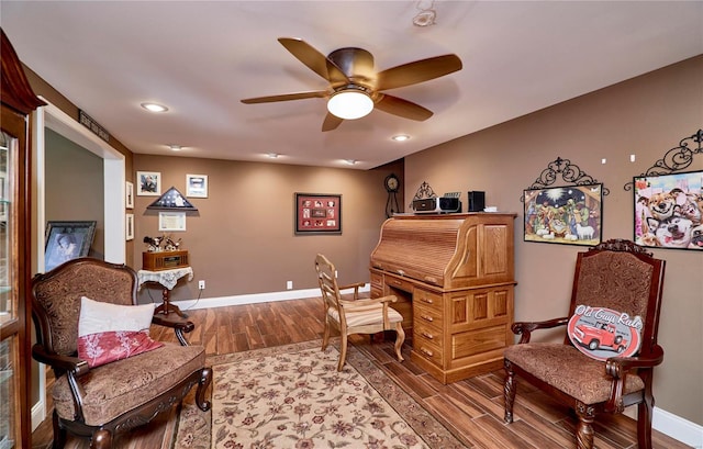 living area featuring ceiling fan and hardwood / wood-style floors