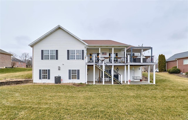 rear view of property with a wooden deck, a yard, central AC, and a patio