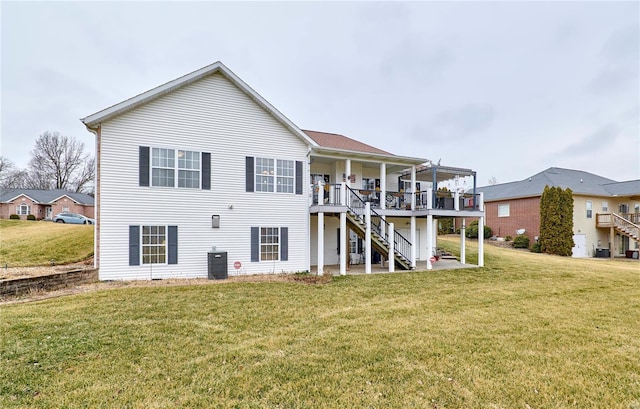 back of house featuring central AC unit, a patio area, a lawn, and a deck