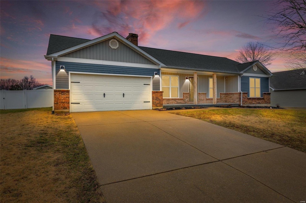 craftsman-style house with a garage and a lawn