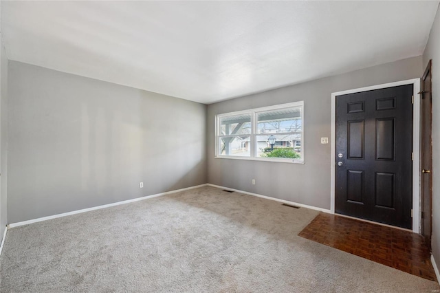 foyer entrance featuring carpet floors