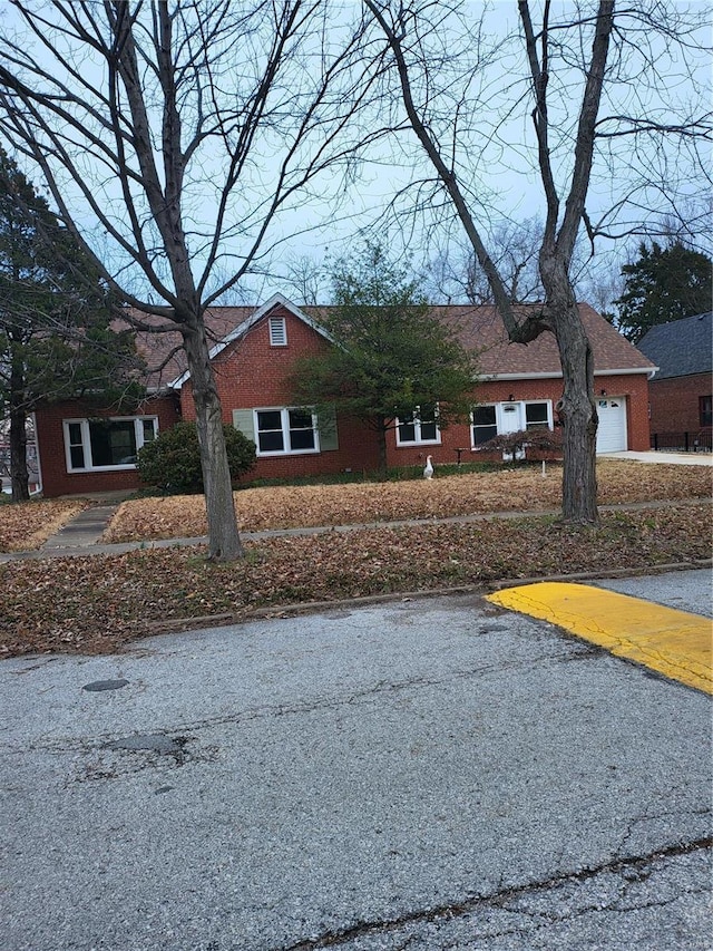 view of front of house with brick siding and an attached garage