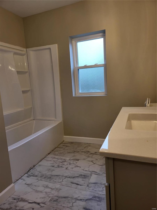 full bathroom with marble finish floor, bathing tub / shower combination, vanity, and baseboards