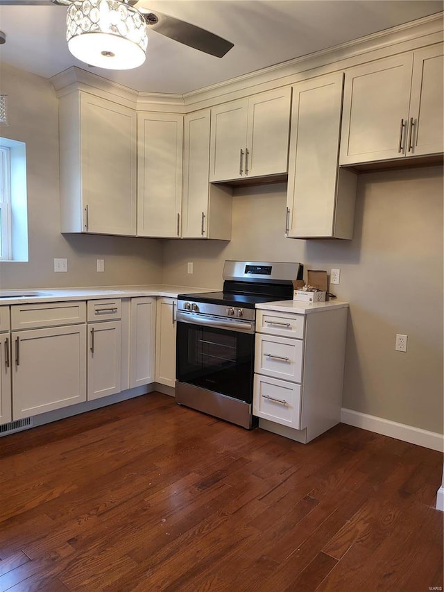 kitchen with visible vents, baseboards, dark wood finished floors, stainless steel electric range, and light countertops