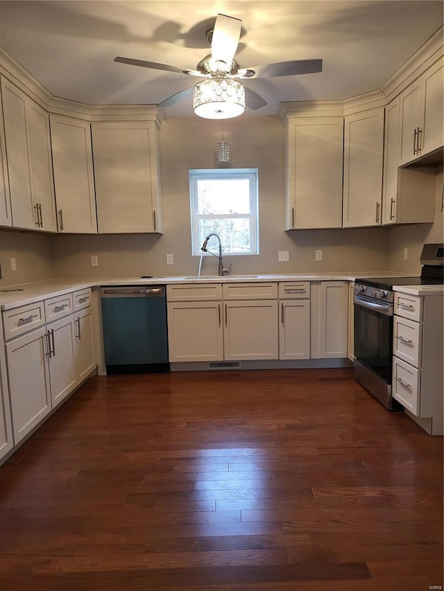 kitchen featuring dishwashing machine, dark wood-type flooring, light countertops, stainless steel range with electric cooktop, and a sink