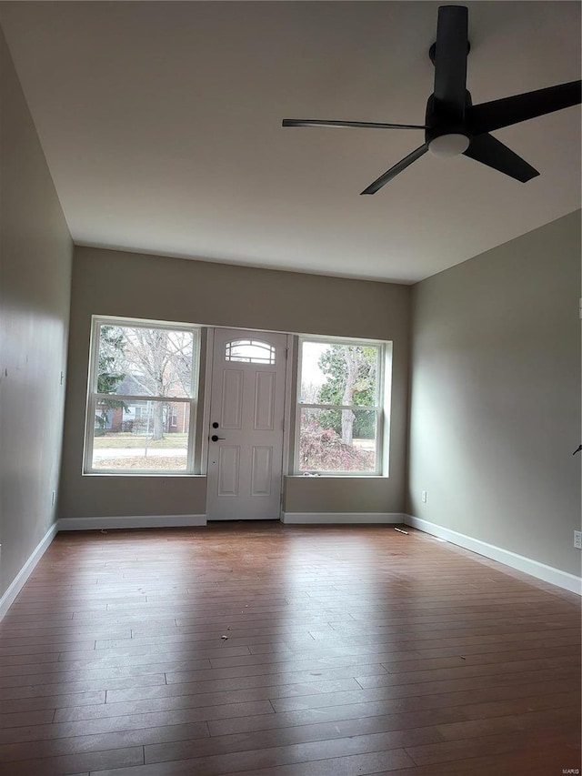 foyer with ceiling fan, baseboards, and hardwood / wood-style flooring