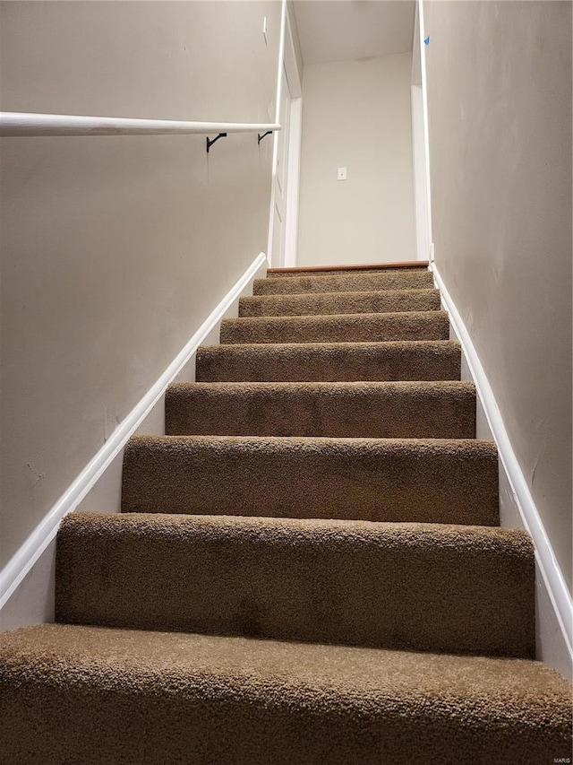 stairway featuring baseboards