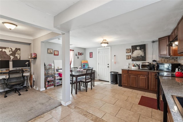 kitchen with light tile patterned flooring, decorative backsplash, and range hood