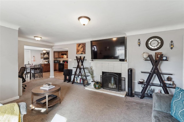 carpeted living room featuring a brick fireplace