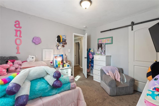 carpeted bedroom with a barn door