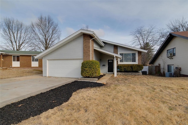 view of front of house with a garage, central AC unit, and a front lawn