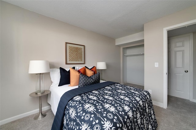 bedroom featuring a closet, carpet floors, and a textured ceiling