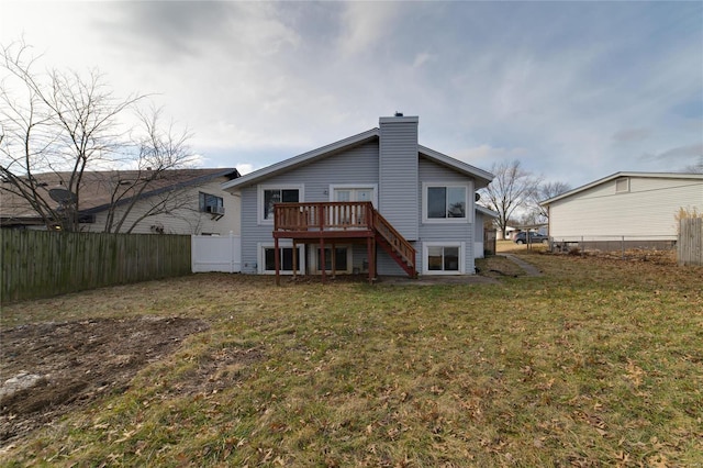 back of house featuring a yard and a deck