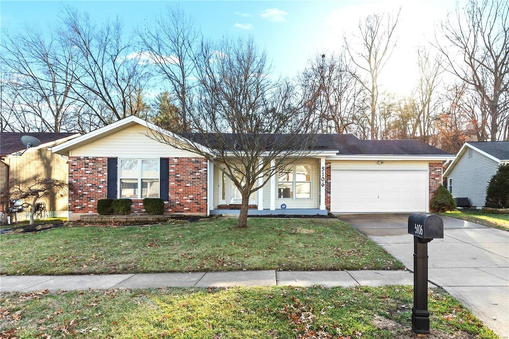 single story home with a garage, a front lawn, and central air condition unit